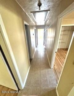 corridor featuring light tile patterned floors