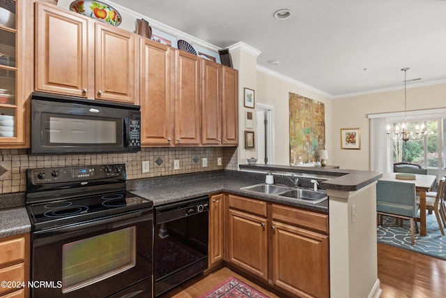 kitchen featuring black appliances, hardwood / wood-style flooring, sink, kitchen peninsula, and ornamental molding