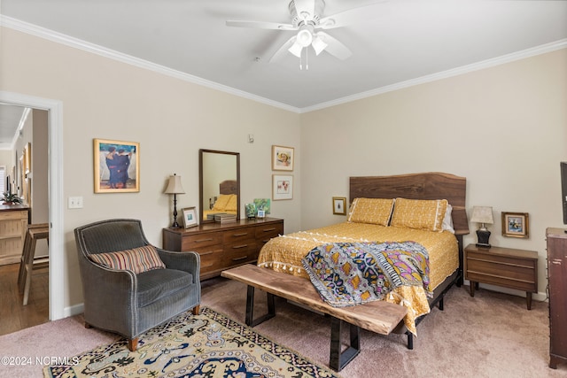 carpeted bedroom with ceiling fan and ornamental molding