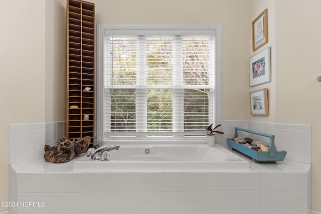 bathroom featuring tiled tub