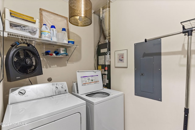 clothes washing area featuring independent washer and dryer, electric panel, and gas water heater