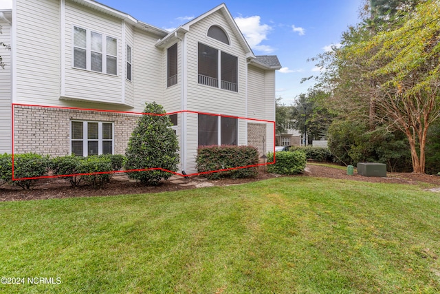 view of property exterior featuring a lawn