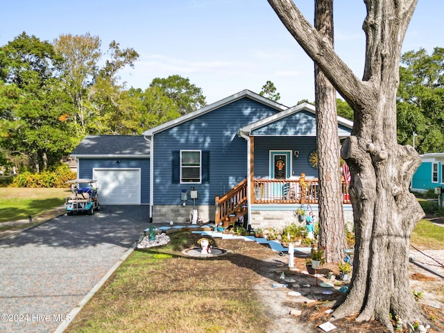 ranch-style home with covered porch, a garage, and a front lawn