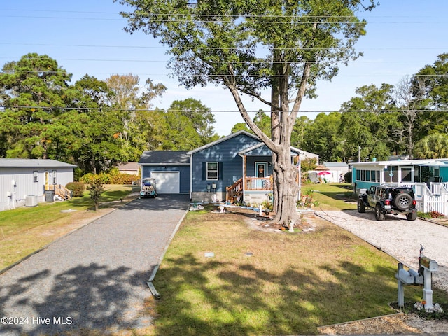 bungalow-style home featuring a porch, a front lawn, and a garage