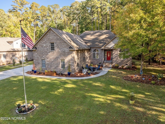 view of front of house with crawl space, brick siding, and a front yard