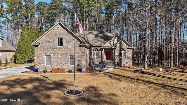 view of front facade with a front lawn and brick siding