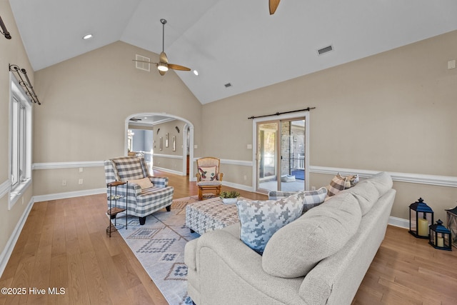 living room featuring high vaulted ceiling, light hardwood / wood-style flooring, and ceiling fan