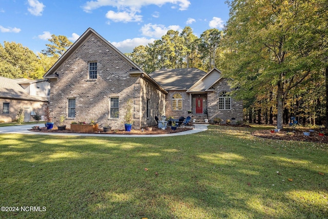 view of front of property featuring brick siding, crawl space, and a front yard