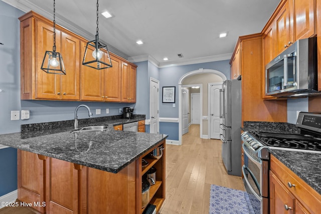 kitchen with kitchen peninsula, appliances with stainless steel finishes, sink, dark stone countertops, and hanging light fixtures