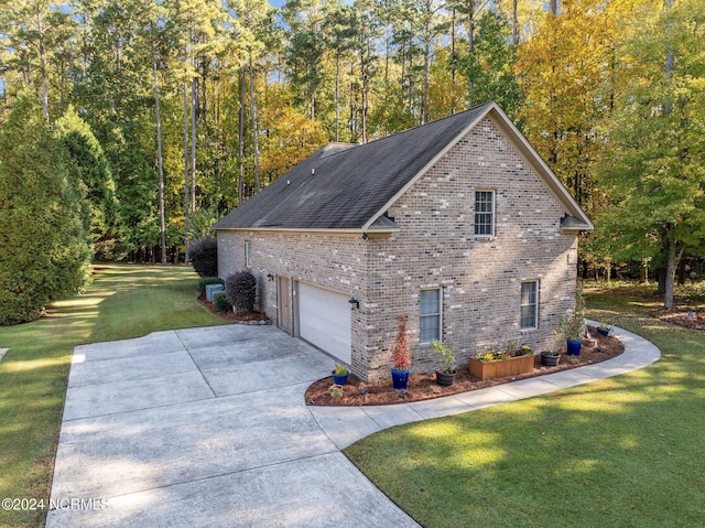 view of property exterior with concrete driveway, a lawn, a forest view, roof with shingles, and brick siding