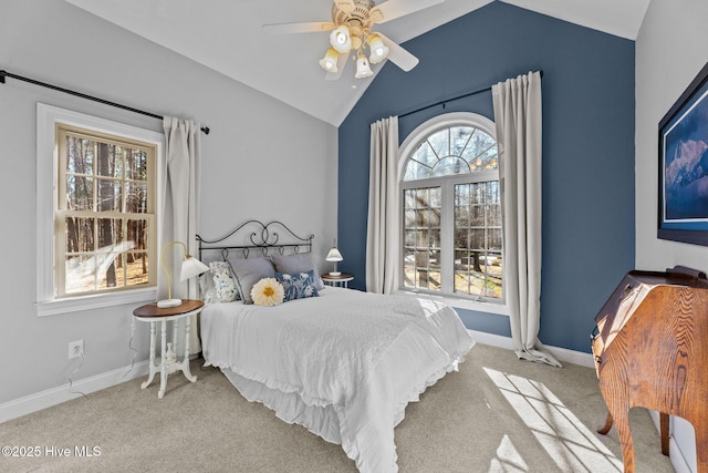 bedroom with multiple windows, light carpet, vaulted ceiling, and ceiling fan