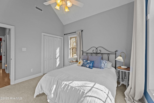 bedroom featuring light colored carpet, high vaulted ceiling, a closet, and ceiling fan