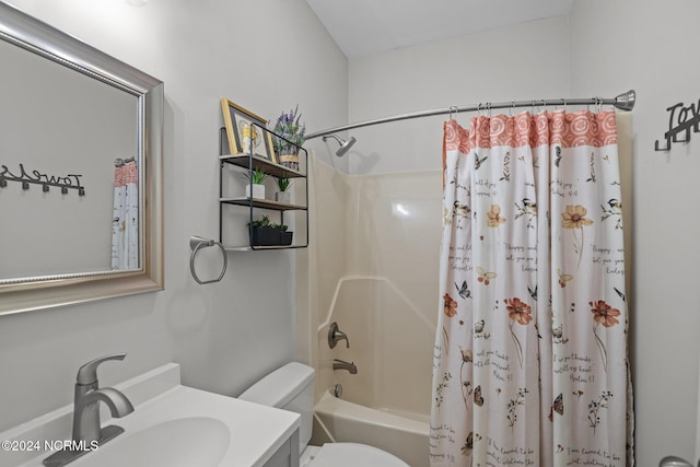 full bathroom with shower / tub combo with curtain, vanity, and toilet