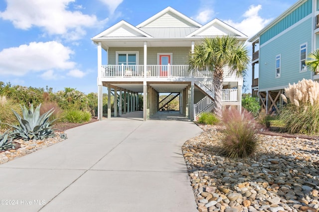 raised beach house with a carport and a porch