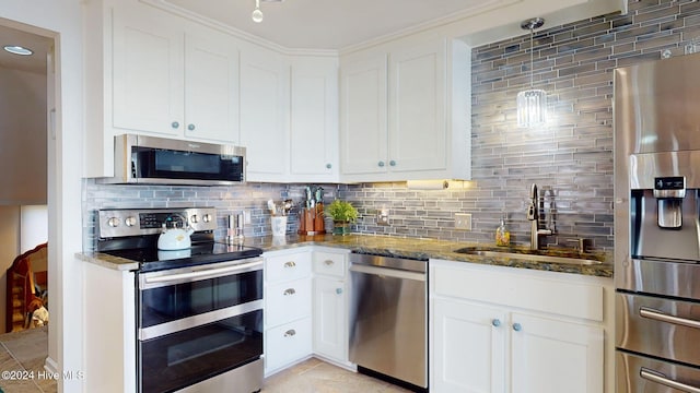 kitchen with backsplash, white cabinetry, sink, and appliances with stainless steel finishes