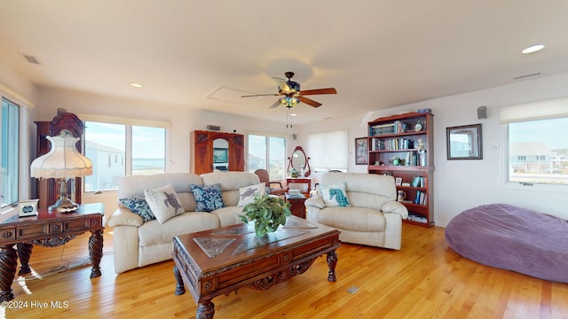 living room featuring ceiling fan and light hardwood / wood-style flooring