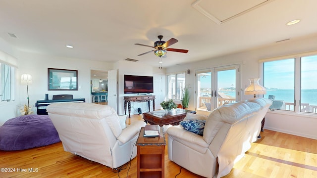 living room with ceiling fan and light hardwood / wood-style floors