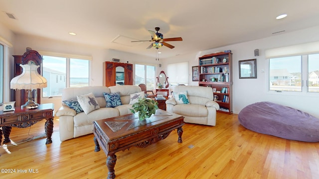 living room featuring light hardwood / wood-style flooring and ceiling fan