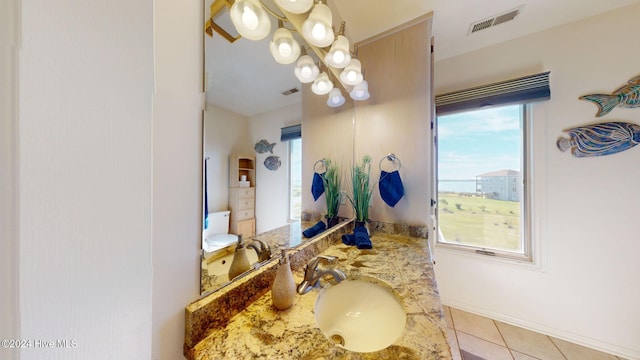 bathroom with tile patterned floors, vanity, and a chandelier