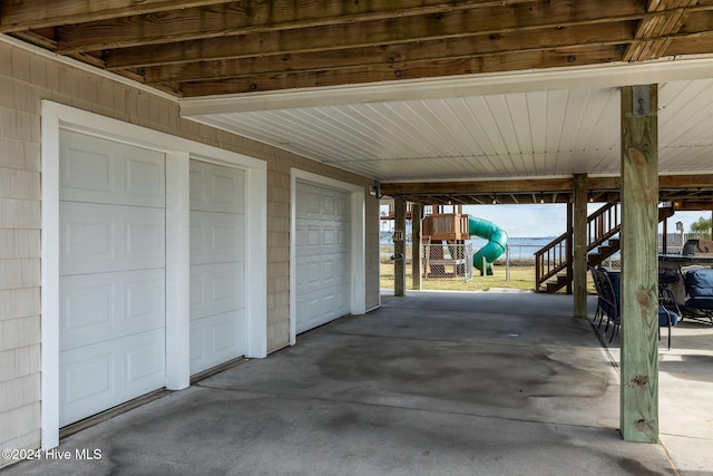 view of patio / terrace with a garage and a carport