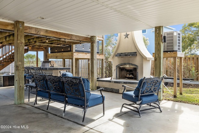 view of patio / terrace with an outdoor living space with a fireplace