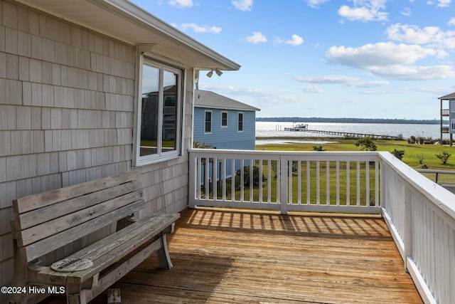 wooden deck featuring a water view