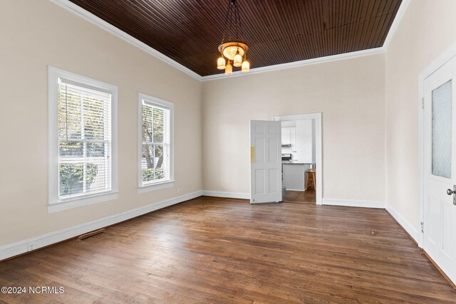 950 Main St, Fair Bluff, NC 28439 - empty room featuring crown molding, a chandelier, dark wood-type flooring, and baseboards