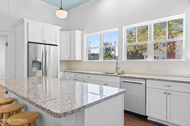 950 Main St, Fair Bluff, NC 28439 - kitchen featuring appliances with stainless steel finishes, a sink, tasteful backsplash, a breakfast bar, and white cabinetry