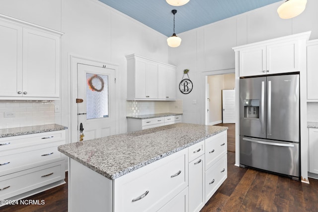 950 Main St, Fair Bluff, NC 28439 - kitchen featuring stainless steel fridge, decorative backsplash, white cabinetry, and dark wood-type flooring