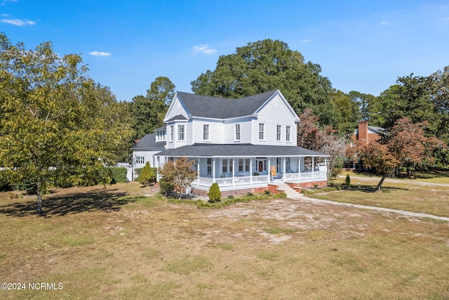 farmhouse inspired home featuring a porch and a front lawn