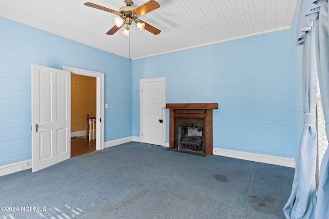 950 Main St, Fair Bluff, NC 28439 - unfurnished living room with carpet flooring, a ceiling fan, and a fireplace with flush hearth