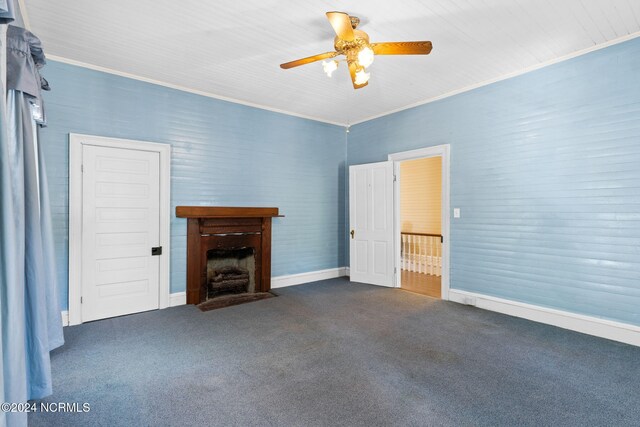 950 Main St, Fair Bluff, NC 28439 - unfurnished living room with a ceiling fan, dark colored carpet, a fireplace with flush hearth, baseboards, and crown molding