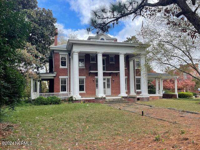 4290 W Church St, Farmville, NC 27828 - neoclassical / greek revival house featuring covered porch, a chimney, and a front yard