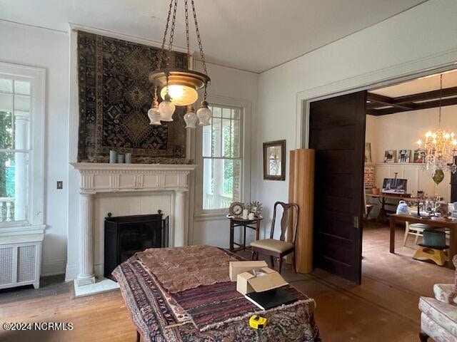 sitting room featuring a chandelier, hardwood / wood-style flooring, and radiator