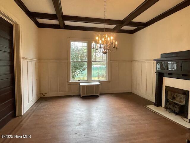 4290 W Church St, Farmville, NC 27828 - unfurnished dining area featuring a decorative wall, beam ceiling, a chandelier, a fireplace with flush hearth, and coffered ceiling