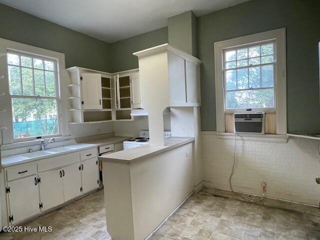 4290 W Church St, Farmville, NC 27828 - kitchen featuring electric range, light countertops, white cabinets, cooling unit, and a peninsula
