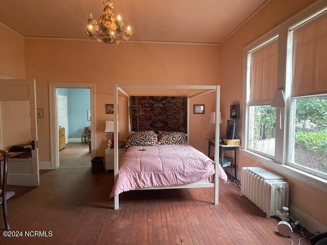 bedroom featuring hardwood / wood-style floors and radiator