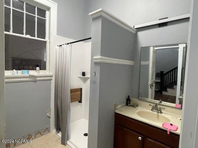 bathroom with vanity, curtained shower, and tile patterned floors