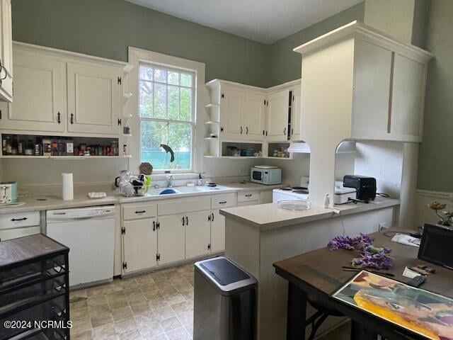 kitchen featuring white dishwasher and white cabinets