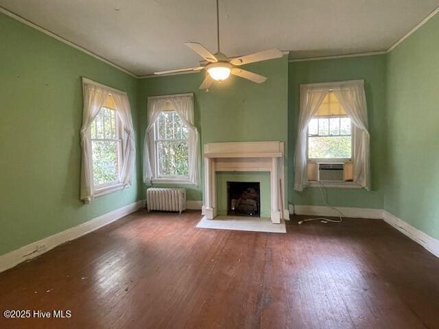 4290 W Church St, Farmville, NC 27828 - unfurnished living room featuring wood-type flooring, ornamental molding, a healthy amount of sunlight, and radiator