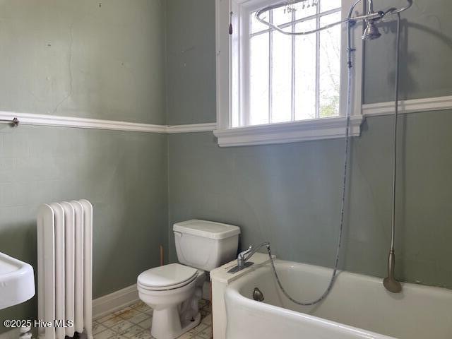 4290 W Church St, Farmville, NC 27828 - full bath with a bathing tub, toilet, a wealth of natural light, and radiator heating unit