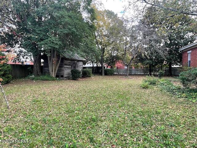 4290 W Church St, Farmville, NC 27828 - view of yard featuring a storage unit, a fenced backyard, and an outbuilding