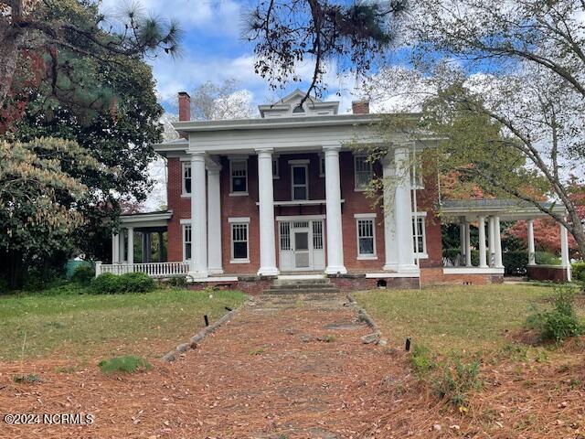 4290 W Church St, Farmville, NC 27828 - greek revival house with a chimney, a porch, and a front yard