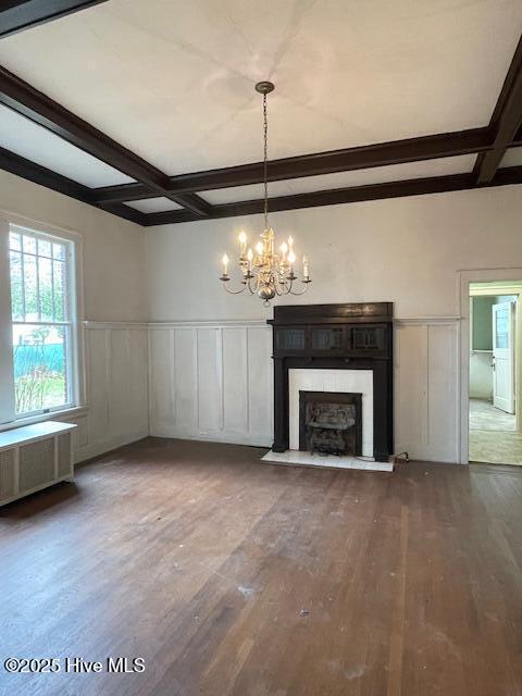 4290 W Church St, Farmville, NC 27828 - unfurnished living room with a decorative wall, wood finished floors, beam ceiling, a chandelier, and coffered ceiling