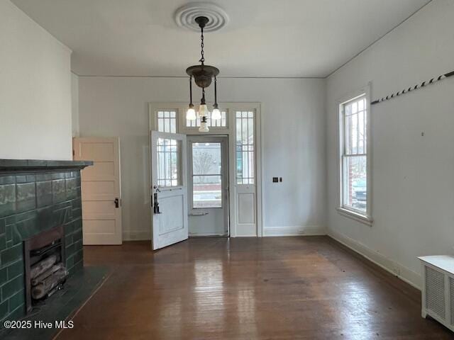 4290 W Church St, Farmville, NC 27828 - doorway to outside featuring baseboards, wood finished floors, and a tile fireplace