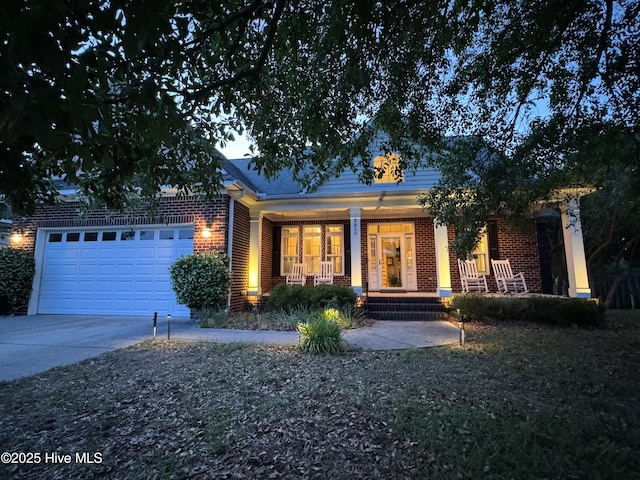 5800 Neelys Ct, Wilmington, NC 28409 - ranch-style home featuring brick siding, covered porch, concrete driveway, and an attached garage