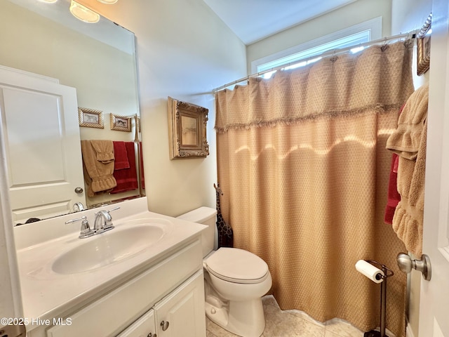 bathroom with vanity, a shower with shower curtain, and toilet