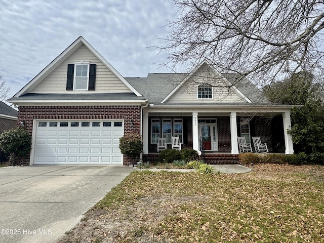 view of front of property featuring brick siding, a porch, concrete driveway, and a garage