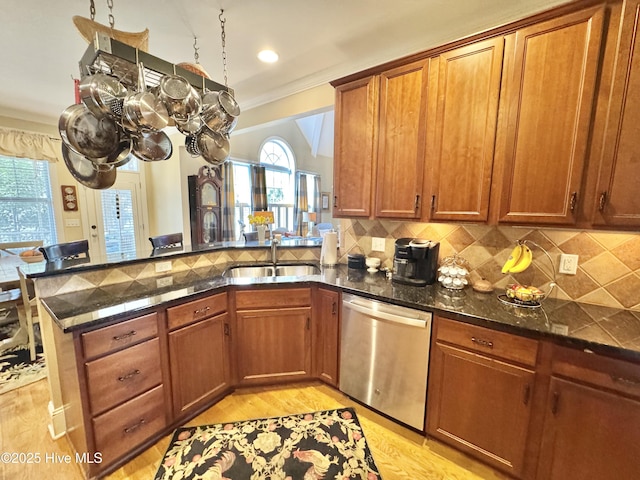 5800 Neelys Ct, Wilmington, NC 28409 - kitchen with dishwasher, a sink, brown cabinetry, light wood finished floors, and a peninsula