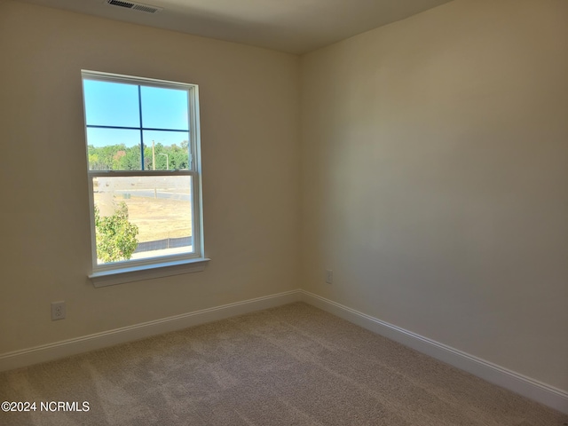 carpeted spare room with baseboards